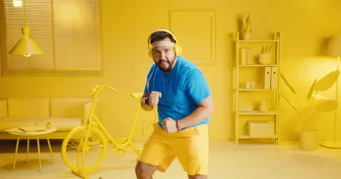 Slow motion of bearded young man doing exercise by running in place and punching Stock Footage 165865247