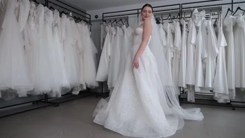 Slow motion of a beautiful bride with a long veil swirling in the wedding salon. Stock Footage 300831318