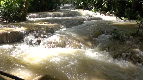 Slow motion of Beautiful Clear Waterfall Cascade In Tropical Rainforest Video stock 255030877