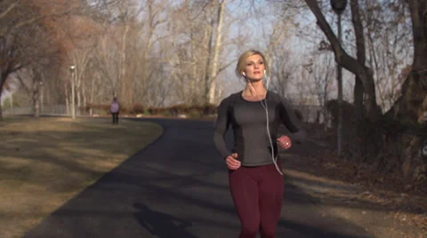 Slow motion of beautiful female runner stopping and smiling (240 fps) Stock Footage 33666092