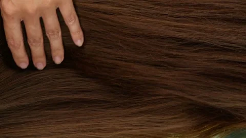 Slow motion of beautiful long smooth straight brown hair extension texture Stock Footage 134457553