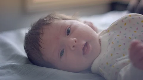Slow motion of beautiful one-month old baby looking at camera Stock Footage 107572675