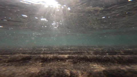Slow Motion Beautiful Sunlight Hitting Into Ocean Waves under Shallow Water Stock Footage 139344881