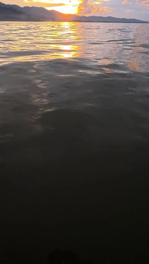 Slow motion of Beautiful sunset on the lake with clouds and mountains Stock Footage 299726372