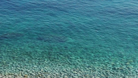 Slow motion of a beautiful transparent paradisiac sea and white stones on the Stock Footage 77899009