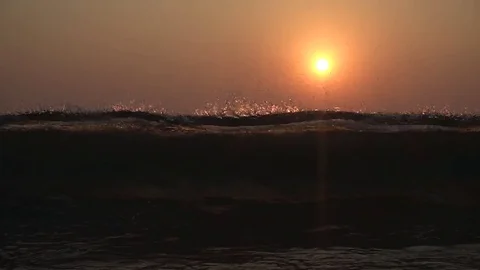 Slow motion of beautiful wave breaking on shore during sunset Stock Footage 79876077