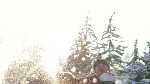 Slow motion. A beautiful young guy and a girl throws snow into the air. A Stock Footage 162084248