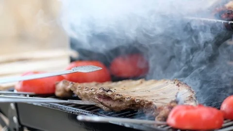Slow Motion Beef Ribs on the Barbecue Stock Footage 114229063