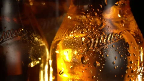 Slow motion as a beer bottle spins on the table Stock Footage 148158092