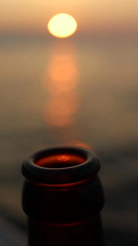 Slow Motion Beer Bottle on Sunset by the Sea (Vertical) Stock Footage 245455985