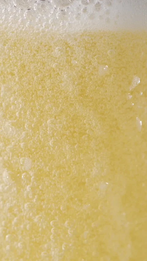 Slow Motion Beer Bubbles and Foam Dance in Golden Liquid Splashes Stock Footage 340078894