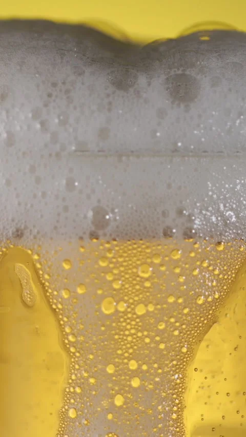 Slow motion beer bubbles and foam rising in a glass Stock Footage 340482463