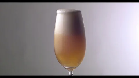 Slow Motion  Beer Foam Overflows Over The Edge Of The Glass Stock Footage 81794378
