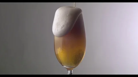 Slow Motion  Beer Foam Overflows Over The Edge Of The Glass Stock Footage 81794462