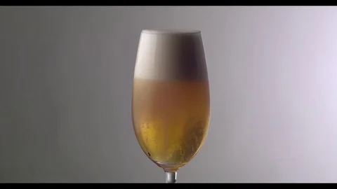 Slow Motion  Beer Foam Overflows Over The Edge Of The Glass Stock Footage 81794597