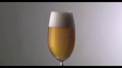 Slow Motion  Beer Foam Overflows Over The Edge Of The Glass Stock-Footage 81794635