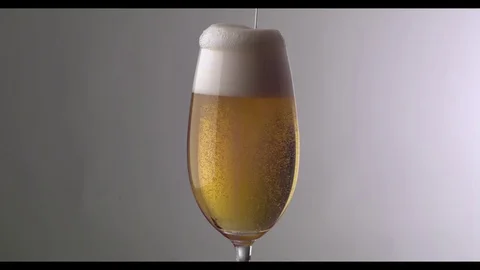 Slow Motion  Beer Foam Overflows Over The Edge Of The Glass Stock Footage 81796225