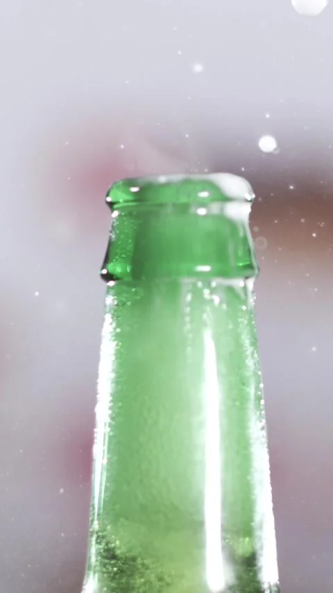 Slow motion beer splash as bottle is opened with foam and bubbles Stock Footage 340482700