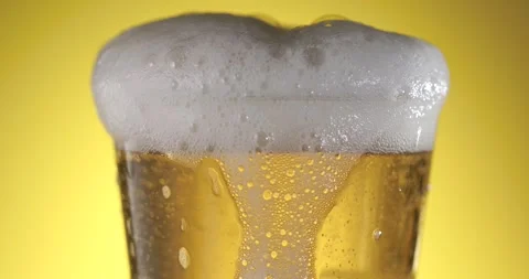 Slow Motion Beer Splashes With Frothy Foam and Vibrant Bubbles Stock Footage 340079020