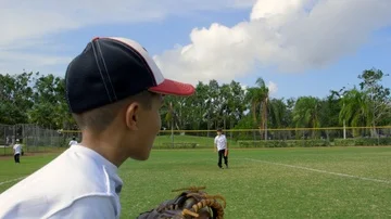 Slow motion from behind of kid as he throws ball during baseball practice Stock Footage 85649080