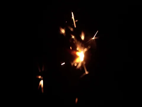 A slow motion of Bengali fire against the black background. Christmas pattern Stock Footage 104678384