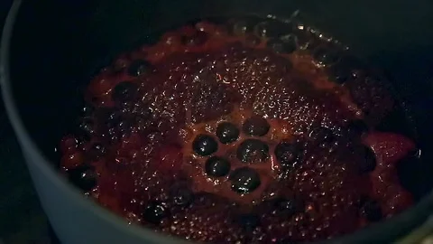 Slow Motion of Berry Sauce boiling in a pan Stock Footage 101284357
