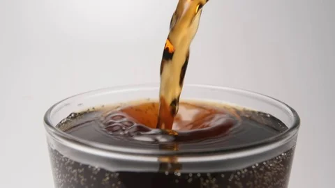 SLOW MOTION: Beverage flows in a glass from a bottle - close up Stock Footage 70804513