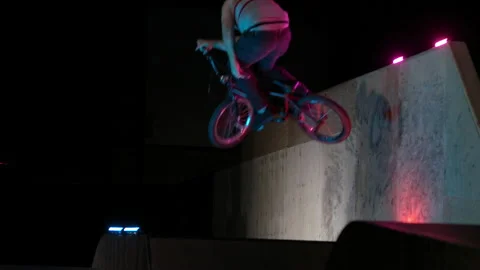 Slow motion big air trick on an indoor skatepark jump Stock Footage 139948299