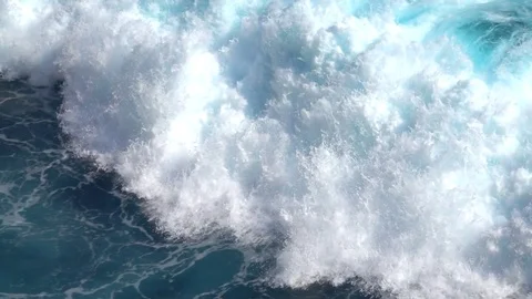 SLOW MOTION Big barreling foamy ocean wave crashing into the rocky reef on beach Stock Footage 79582091