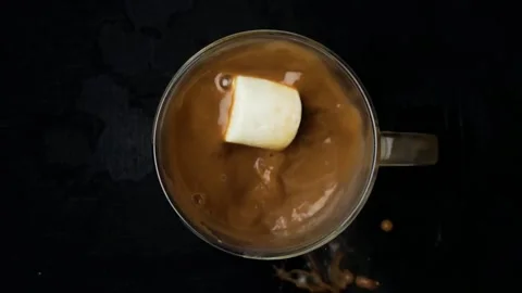 Slow Motion Big Marshmallows dropped into hot chocolate Stock Footage 169028609