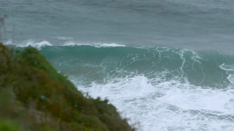 Slow motion of big ocean waves wilding and swaying towards solid ground on shore Stock Footage 156084742