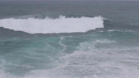 Slow motion of big ocean waves raging towards solid ground on cloudy day Stock Footage 156085519