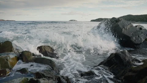 Slow Motion of Big Sea Waves Splashing on Rocks on the Coast, 4K Stock Footage 257682715