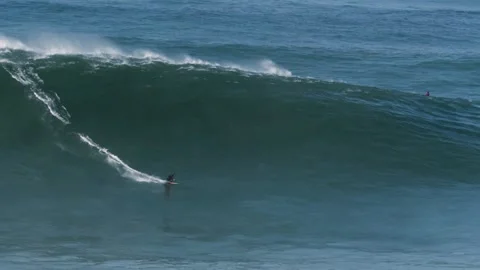 Slow motion of a big wave surfer riding a monster wave in Nazaré, Stock Footage 142413638