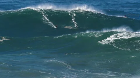 Slow motion of a big wave surfers sharing a monster wave in Nazaré, Stock Footage 142461545