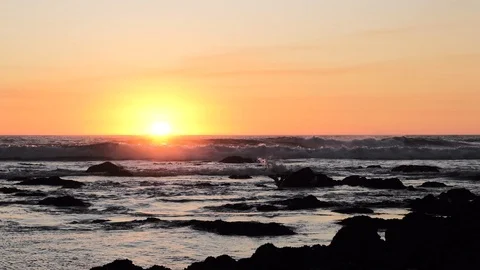 Slow motion big waves breaking on ocean at sunset, as bird flies in silhouette Stock Footage 115863450