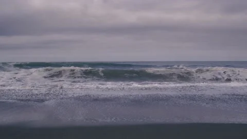 Slow motion big waves crash against the beach on the Oregon coast Stock Footage 147744065