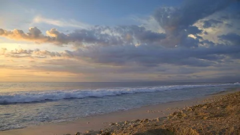 Slow motion of big waves on rocky beach in high tide during warm sunset Video stock 115037849