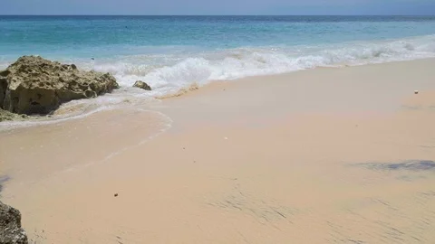 Slow motion of big waves on a tropical beach with yellow and black sand Video stock 115018308
