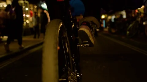 Slow motion of bike being ridden at night in the city Stock Footage 84483138