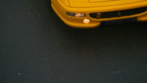 Slow motion birds eye view shot of yellow sports car driving past Stock Footage 101826692