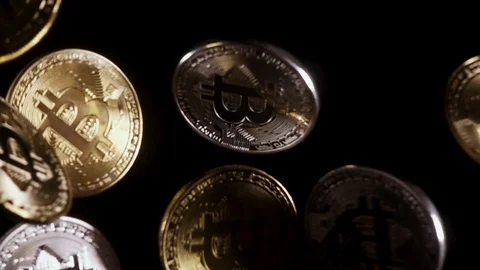 Slow motion bitcoins are falling from under the cameras Video stock 85472371