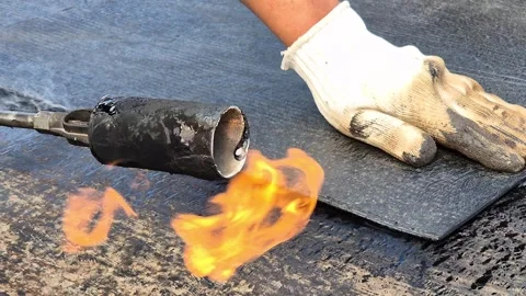 Slow Motion Bitumen Waterproofing Installation with Torch Flame Stock Footage 344431723