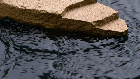 Slow motion of black water surface splashes, waves, ripples with golden stone Stock Footage 276445871