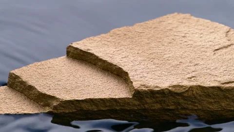 Slow motion of black water surface splashes, waves, ripples with golden stone Video stock 280823573