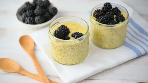 Slow motion of blackberries dropping into overnight chia seeds yogurt 스톡 동영상 112733353