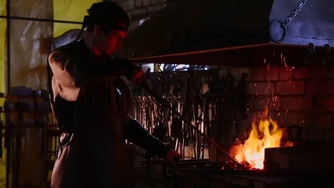Slow Motion Blacksmith Forging a Sword Stock Footage 73975390