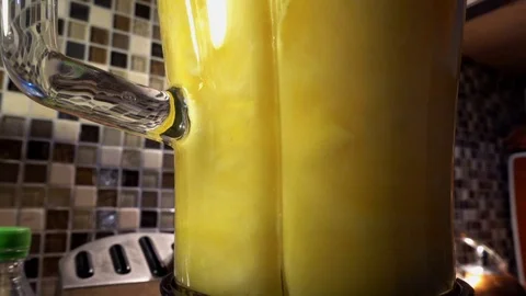 Slow motion of blender making fresh orange juice Stock Footage 94860278