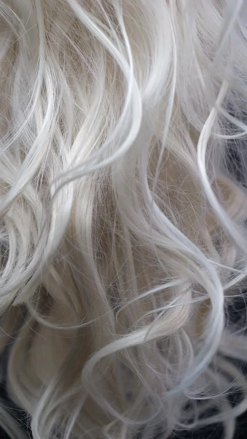 In slow motion, blonde hair flows across a black backdrop, filling the scre.. Stock-Footage 284872947