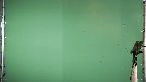 Slow motion blood squibs exploding, spraying blood across the screen on green Stock Footage 92654369